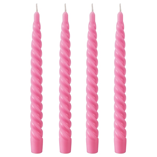 Four pink twisted candles lined up, made of paraffin and plant-based wax, with cotton wicks, on white background.