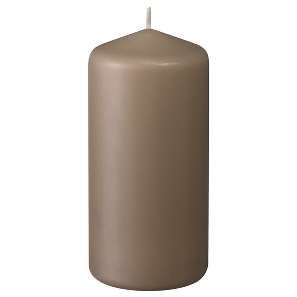 A brown DAGLIGEN pillar candle, made of paraffin and plant wax, with a cotton wick, standing upright with a smooth, cylindrical design.