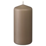 A brown DAGLIGEN pillar candle, made of paraffin and plant wax, with a cotton wick, standing upright with a smooth, cylindrical design.