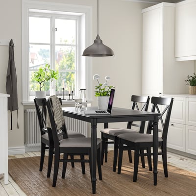 A DANDERYD dining set with a black rectangular table and grey chairs, perfectly fitting in a bright kitchen nook.