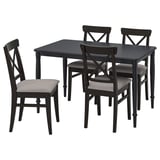 Black wooden chairs with grey cushions around black square dining table.
