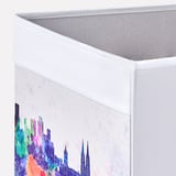 Foldable storage box with vibrant city print. Made from recycled materials. Handle on two sides for easy access.