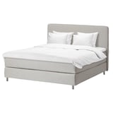 A modern, light gray DUNVIK bed in a minimalist style with clean lines, featuring a upholstered headboard, white bedding, and sturdy metal legs.