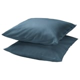 Two square blue DVALA pillows, made of 100% cotton, neatly stacked against a white background, showcasing their smooth texture and simple design.