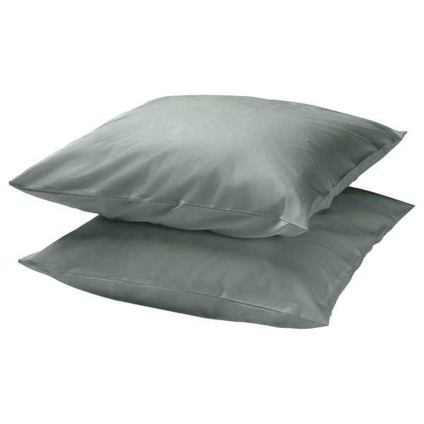 Two square grey-green DVALA pillowcases made of cotton, stacked neatly.
