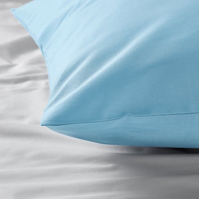 Light blue pillowcase on white bedding, displaying smooth texture and even stitching.