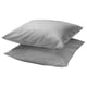 Two stacked light grey square pillows with smooth, simple design.