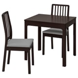 The EKEDALEN set a dark brown extendable table and two matching chairs with gray cushions.
