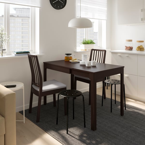 Modern kitchen with EKEDALEN dining set, pendant light, dishes, plant, and blinds.