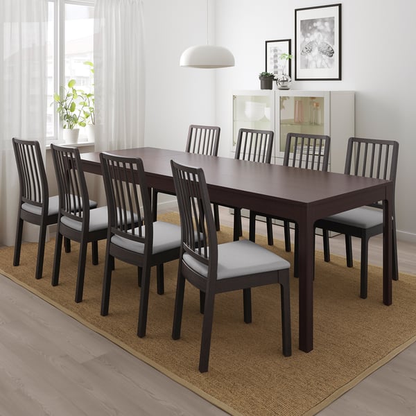 EKEDALEN dark brown extendable dining table with 6 light grey cushioned chairs. Large, rectangular, modern design fits well in spacious rooms.