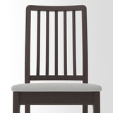 Dark wooden chair with light gray cushioned seat; sturdy, elegant design.