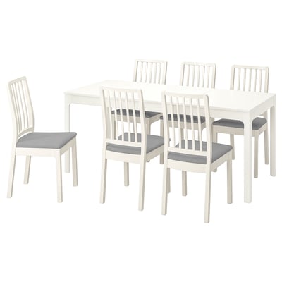 A white EKEDALEN extendable dining set with six padded chairs.