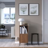 Modern living room with EKET unit, books, decor, lamp, stool, and photos.