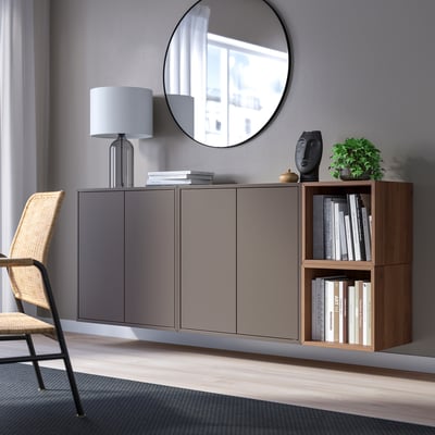 Modern storage: gray EKET cabinet, wooden shelf, mirror, lamp, wicker chair.