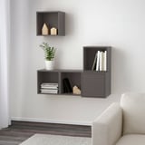Modern wall-mounted shelves showcasing books and plants. Asymmetric design offers both open and closed storage.