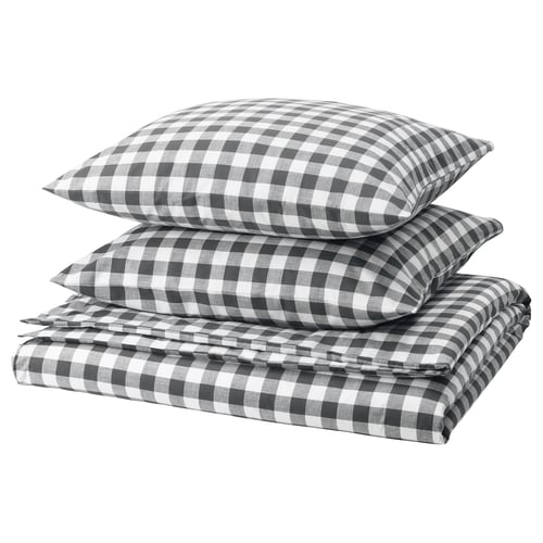 Folded grey-white chequered duvet and pillow set in black and white. Organic cotton, zipped, square patterns.