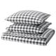 Option: Folded grey-white checkered duvet and pillow set in black and white. Organic cotton, zipped, square patterns.