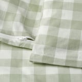 A light green and white checkered duvet cover with a visible zipper closure. Part of an organic cotton bedding set.
