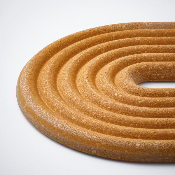 Circular bamboo trivet with concentric rings, lacquered finish, protect surfaces from heat.