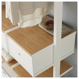 Modular storage unit with adjustable shelves & drawers, bamboo top, white frame. Belt & wallet shown on shelf.