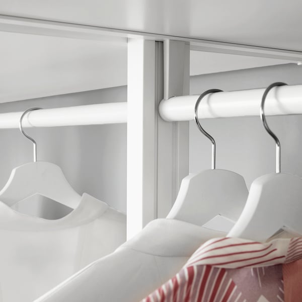 White closet with hanging rods and hangers. Drawers and shelves adjust to fit clothing.