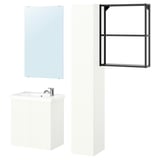 Modern white bathroom setup: mirror, cabinet, and shelves. Sleek, minimalist design for compact spaces.