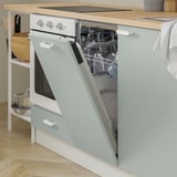 A modern kitchen with an open-fronted cabinet displaying stacked dishes and a built-in dishwasher underneath.