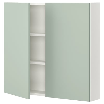 ENHET wall cabinet in light green with two shelves. Gray-green front and modern design.