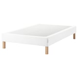 A white ESPEVÄR bed frame with wooden legs. Its simple, modern, and sturdy, designed to raise beds and support mattresses.