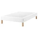 White espevar platform bed with wooden legs.