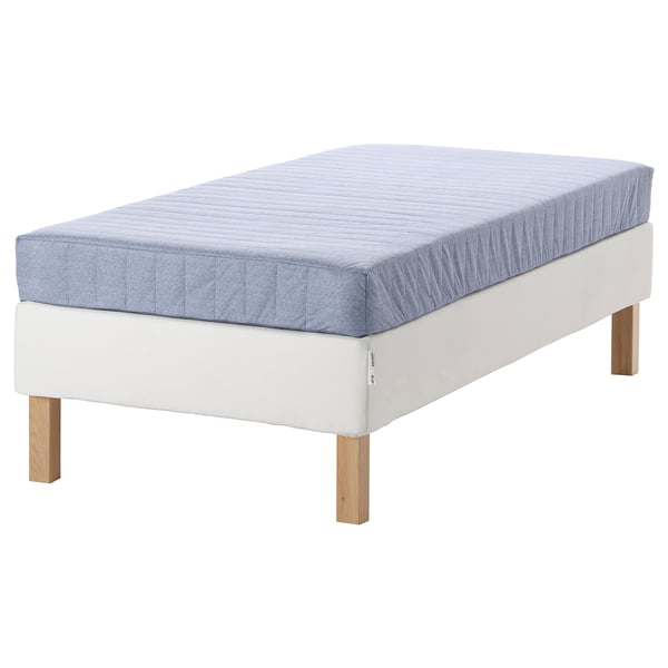 White bed with light blue mattress, wooden legs, firm support, soft top layer.