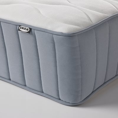 Close-up of an IKEA mattress corner, showcasing quality stitching and soft fabric.