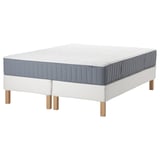Modern white bed frame with grey mattress, wooden legs, and quilted top.