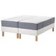 Option: Two blue and white mattresses on white frames with wooden legs.