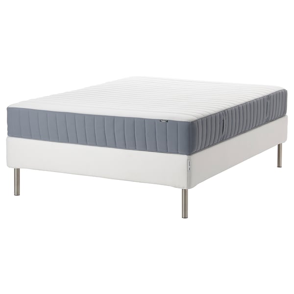 An espevar/valevag bed with a white and blue mattress on a white upholstered frame.
