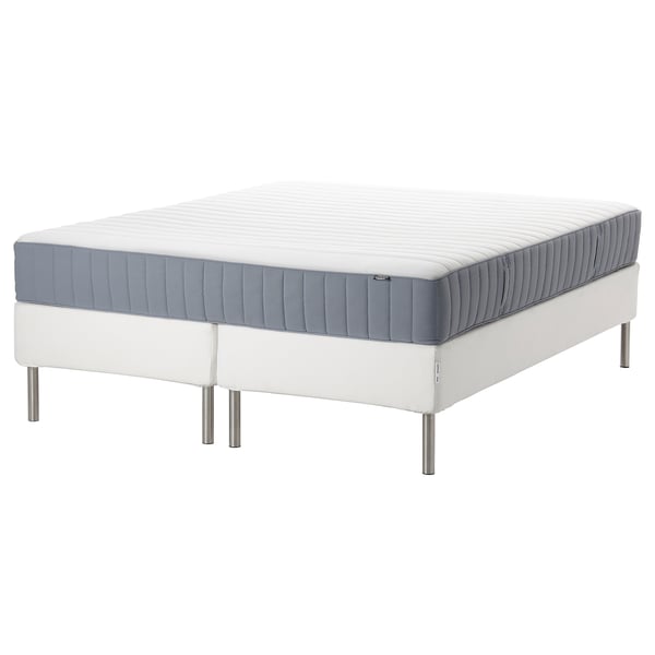 Modern white bed frame with gray mattress, stainless steel legs, minimalist design.