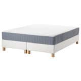 White bed with blue mattress, wooden legs. IKEA ESPEVÄR/VALEVÅG set.