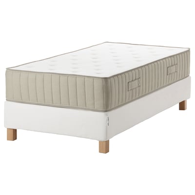 This image shows an espevar/vatnestrom mattress set with white fabric and wooden legs, featuring a padded top design.