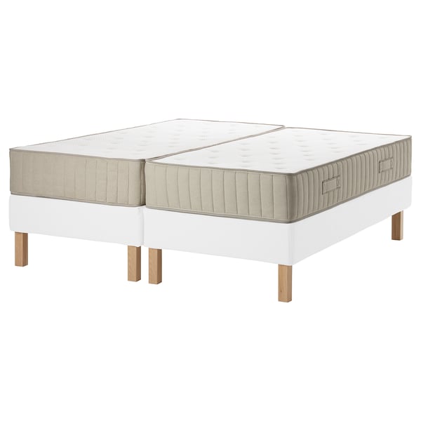 The ESPEVÄR/VATNESTRÖM bed base and mattresses. Its white with wooden legs, featuring a clean and modern design.