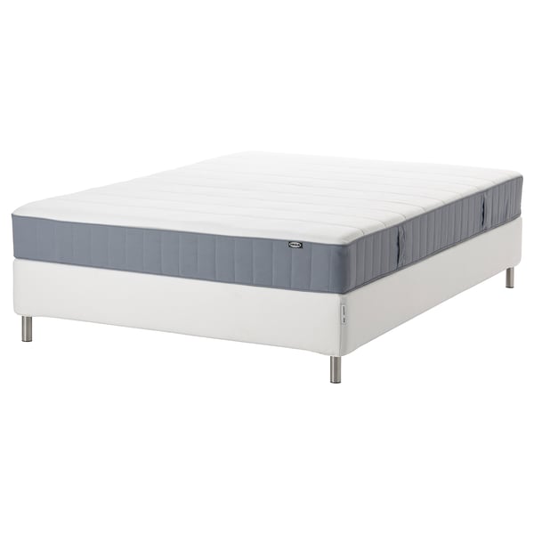 White and gray rolled mattress on white bed frame.