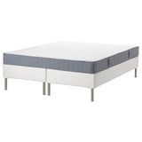 A white and gray roll-packed bonnell spring mattress on a white bed base with stainless steel legs, offering stable support and even comfort.