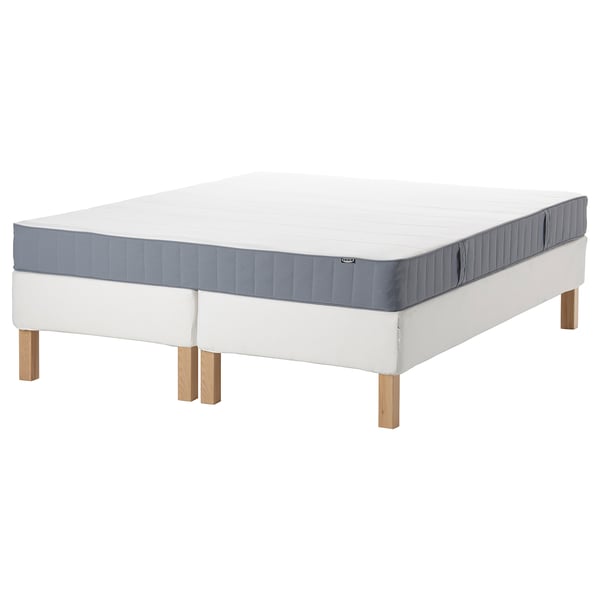 IKEA espevär white mattress base with gray, rectangular, wooden legs and gray bordered top mattress.