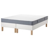 IKEA espevär white mattress base with gray, rectangular, wooden legs and gray bordered top mattress.