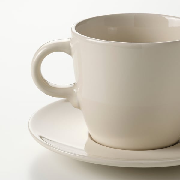 Simple, elegant white cup on saucer, smooth glaze, sturdy handle. Modern classic design.