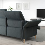 Modern black FAMMARP sofa with adjustable sections, tv console, and wall art.