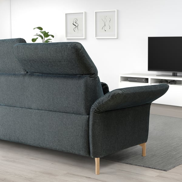 Modern blue sectional sofa in living room with adjustable parts, tv, and wall art.