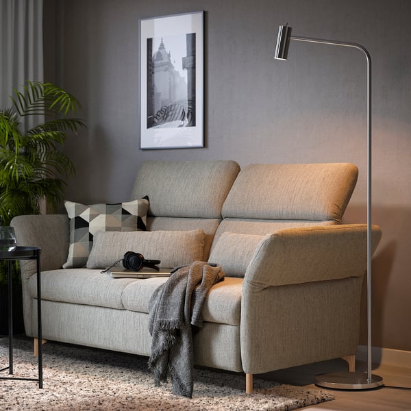 Modern living room: gray FAMMARP sofa, pillows, throw, lamp, plant.