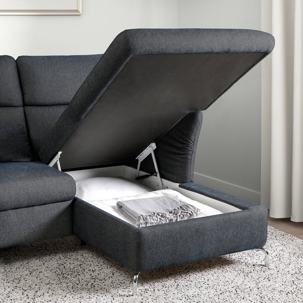 Dark grey FAMMARP sofa with storage; hinge lid open, blanket inside.