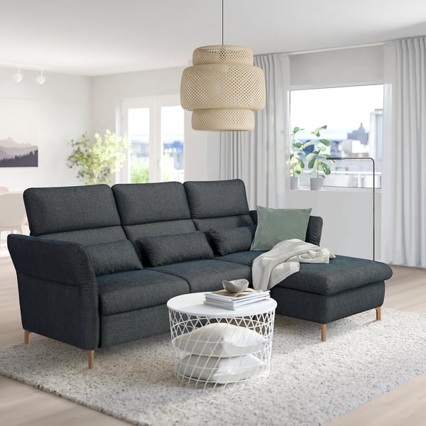 Modern living room with FAMMARP sofa, adjustable head and armrests. White coffee table and round lamp create cozy, stylish space.