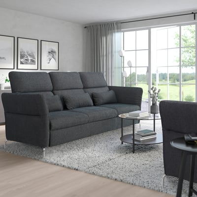 Modern living room with grey FAMMARP sectional, large windows, and cozy decor.